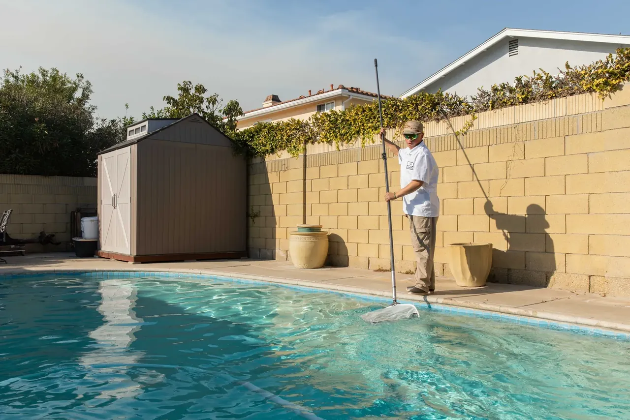 A Long Beach backyard pool being serviced after an equipment failure