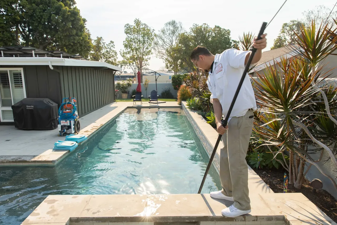 A Long Beach lap pool being cleaned, water still dull