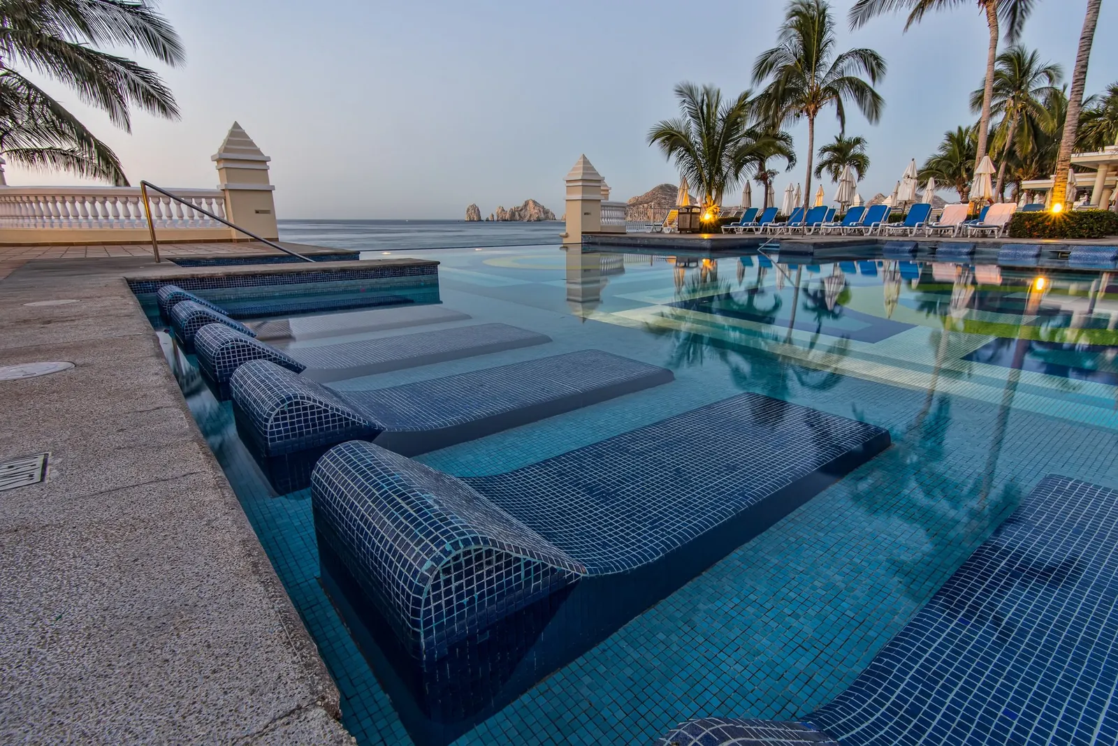 Commercial pool with blue lane dividers and waterfront landscaping
